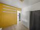 Laundry area with yellow brick wall and white cabinets at 4608 S Shamrock Rd, Tampa, FL 33611