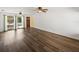 Bright living room featuring wood-look floors and sliding doors to the patio at 4608 S Shamrock Rd, Tampa, FL 33611