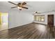 Living area with wood-look floors and multiple ceiling fans at 4608 S Shamrock Rd, Tampa, FL 33611