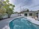 Sparkling kidney-shaped pool, surrounded by a fence and a pergola at 4608 S Shamrock Rd, Tampa, FL 33611