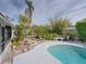 Inviting kidney-shaped pool and well-manicured landscaping at 4608 S Shamrock Rd, Tampa, FL 33611