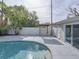 Peaceful kidney-shaped pool with a pergola and fence at 4608 S Shamrock Rd, Tampa, FL 33611