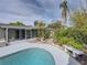 Relaxing kidney-shaped pool with lush landscaping at 4608 S Shamrock Rd, Tampa, FL 33611