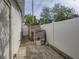 Side yard with sheds and concrete pathway at 4608 S Shamrock Rd, Tampa, FL 33611