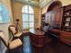 Elegant home office features built-in cabinetry, hardwood floors, and a large window at 8376 Catamaran Cir, Lakewood Ranch, FL 34202