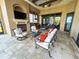 Covered patio features an outdoor kitchen, fireplace, and comfortable seating at 8376 Catamaran Cir, Lakewood Ranch, FL 34202