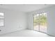 Bright bedroom with tile floors and sliding glass doors leading to the backyard at 9024 Evelyn Rd, Englewood, FL 34224