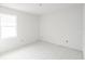 Simple bedroom with a large window and tiled floors at 9024 Evelyn Rd, Englewood, FL 34224