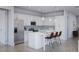 Modern white kitchen with stainless steel appliances and an island at 9024 Evelyn Rd, Englewood, FL 34224