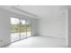 Bright and airy living room with large sliding glass doors and tiled floors at 9024 Evelyn Rd, Englewood, FL 34224