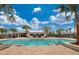 Resort-style pool with palm trees and clubhouse at 6216 Golden Beach Dr, Apollo Beach, FL 33572