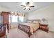 Main bedroom with a king-size bed and a ceiling fan at 21489 Billowy Jaunt Dr, Land O Lakes, FL 34637