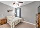 Cozy bedroom with a double bed, dresser, and ceiling fan at 21489 Billowy Jaunt Dr, Land O Lakes, FL 34637