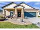 House exterior showcasing a two-car garage, manicured lawn, and inviting porch at 21489 Billowy Jaunt Dr, Land O Lakes, FL 34637