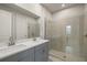 Modern bathroom with double vanity and glass shower at 6162 Timberdale Ave, Wesley Chapel, FL 33545