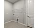 Laundry room with wire shelving and tile floor at 6162 Timberdale Ave, Wesley Chapel, FL 33545