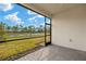 Screened porch overlooking a pond and lush landscape at 6162 Timberdale Ave, Wesley Chapel, FL 33545