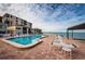 Community pool and spa with waterfront views and lounge chairs at 6180 Sun Blvd # 204, St Petersburg, FL 33715