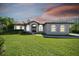 Beautiful home with lighted entryway and manicured lawn at 6522 Spyglass Ln, Bradenton, FL 34202