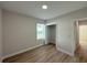 Bright bedroom with a window, closet, and wood-look flooring at 10402 Pendleton Ave, Englewood, FL 34224