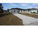 New gray house with gray pavers driveway and landscaping at 10402 Pendleton Ave, Englewood, FL 34224