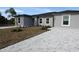 New gray house with gray pavers driveway and landscaping at 10402 Pendleton Ave, Englewood, FL 34224