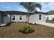 New gray house with palm tree and gray pavers walkway at 10402 Pendleton Ave, Englewood, FL 34224