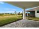 Covered patio with view of grassy backyard and preserve at 11170 Livewell Ct, Venice, FL 34293