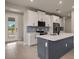 Modern kitchen with white cabinets, a large island, and stainless steel appliances at 11170 Livewell Ct, Venice, FL 34293