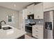 Modern kitchen with white cabinets, stainless steel appliances, and a large island at 11170 Livewell Ct, Venice, FL 34293