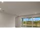 Living room with sliding glass doors opening to a backyard patio at 11170 Livewell Ct, Venice, FL 34293