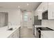 Modern kitchen with stainless steel appliances and white cabinets at 11211 Livewell Ct, Venice, FL 34293