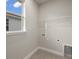 Laundry room with window, shelving and tile floor at 11211 Livewell Ct, Venice, FL 34293