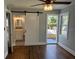 Bedroom with hardwood floors, ceiling fan, and barn door to bathroom at 3631 4Th N Ave, St Petersburg, FL 33713