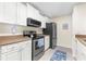 Well-lit kitchen featuring white cabinets, stainless steel appliances, and neutral countertops at 9481 Highland Oak Dr # 512, Tampa, FL 33647