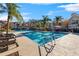 Community pool surrounded by palm trees and lounge chairs at 9481 Highland Oak Dr # 512, Tampa, FL 33647