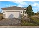 House exterior featuring a two-car garage and well-manicured landscaping at 11294 Boundless Ter, Venice, FL 34293