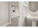 Small powder room with pedestal sink and view into kitchen at 11294 Boundless Ter, Venice, FL 34293