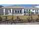 Backyard view of house with covered patio behind a black metal fence at 1578 Running Tide Pl, Sarasota, FL 34240