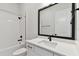 Modern bathroom with white vanity, bathtub, and black accents at 1578 Running Tide Pl, Sarasota, FL 34240