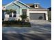 Two-story home with gray garage and landscaped yard at 1578 Running Tide Pl, Sarasota, FL 34240