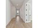 Long hallway with light hardwood floors and recessed lighting at 1578 Running Tide Pl, Sarasota, FL 34240