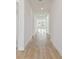 Bright hallway with light hardwood floors and recessed lighting at 1578 Running Tide Pl, Sarasota, FL 34240