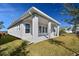 Rear view of house showing covered patio and well-manicured lawn at 1578 Running Tide Pl, Sarasota, FL 34240