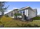 Side view of house showcasing landscaping and covered patio at 1578 Running Tide Pl, Sarasota, FL 34240