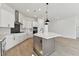 Modern kitchen with white cabinets, stainless steel appliances, and herringbone backsplash at 1578 Running Tide Pl, Sarasota, FL 34240