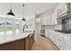 Modern kitchen with white cabinets, quartz countertops, and a large island at 1578 Running Tide Pl, Sarasota, FL 34240