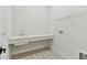 Convenient laundry room with utility sink and patterned tile at 1578 Running Tide Pl, Sarasota, FL 34240