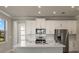 Modern kitchen with white cabinets, stainless steel appliances, and quartz countertops at 11267 Boundless Ter, Venice, FL 34293