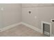 Laundry room with tile flooring and built in shelving at 11267 Boundless Ter, Venice, FL 34293
